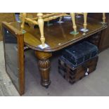 A Victorian round-cornered oak wind-out dining table, raised on fluted legs, L145cm extending to