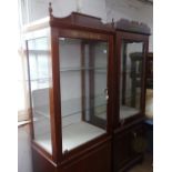 A modern mahogany shop display cabinet, with glazed door to the top and cupboards under, on