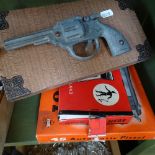 A boxed replica 45 pistol, a Gat air pistol, a toy Luger pistol, and another
