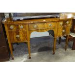 A mahogany cross-banded bow-front sideboard, with fitted drawers and cupboards, raised on 6