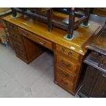 A hardwood twin-pedestal writing desk, with fitted drawers