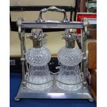 A silver plated tantalus, with 2 cut-glass decanters and stoppers, unsigned