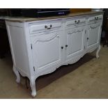 A painted and limed oak dresser base, with 3 frieze drawers and fielded panelled cupboards under, on