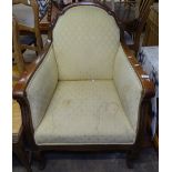 An Edwardian upholstered and carved oak-framed Club chair