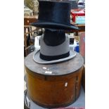 A bentwood hat box, 2 Lincoln Bennett top hats, and a mortar board