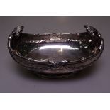 An Edwardian silver boat design dish, of scrolled form, with embossed swag decoration, 5.3oz,