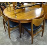 A mid-century G-Plan teak fresco cross-banded circular extending dining table, with integral spare