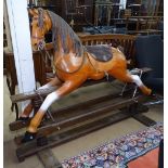 A large painted wood rocking horse on stand, H124cm, L160cm