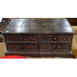 A hardwood centre standing coffee table, with 4 short drawers and all over carved decoration,