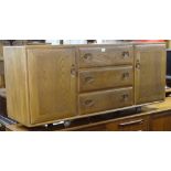 An Ercol elm sideboard, with 3 frieze drawers and panelled cupboards, W155cm, H69cm