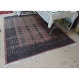 A salmon ground Turkish style rug, 262cm x 187cm