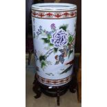 A large Oriental design cylindrical vase, with all over decoration on stand, overall height 80cm,