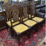 6 French carved and panelled oak chairs with drop-in seats, and face carved panelled backs