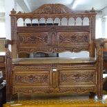 A Victorian light oak hall settle, with carved and panelled Arcadian back, L115cm