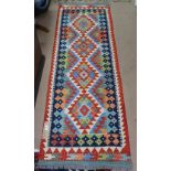 A Choli Kilim runner, 203cm x 65cm, and a similar rug 50cm x 50cm (2)