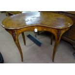 A Victorian figured walnut kidney-shaped writing table, with single frieze drawer, raised on