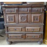 A 17th/18th century oak 2-section chest, with 4 long drawers having moulded fronts, on bun feet,