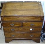 A good quality reproduction oak bureau in Georgian style, fall front opening to reveal a stepped