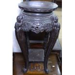 An Oriental pierced and carved jardiniere stand, on cabriole legs, H76cm