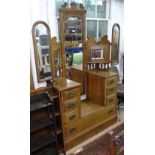 An Art Nouveau oak drop-centre triple-mirror dressing table, with short and fitted long drawers,