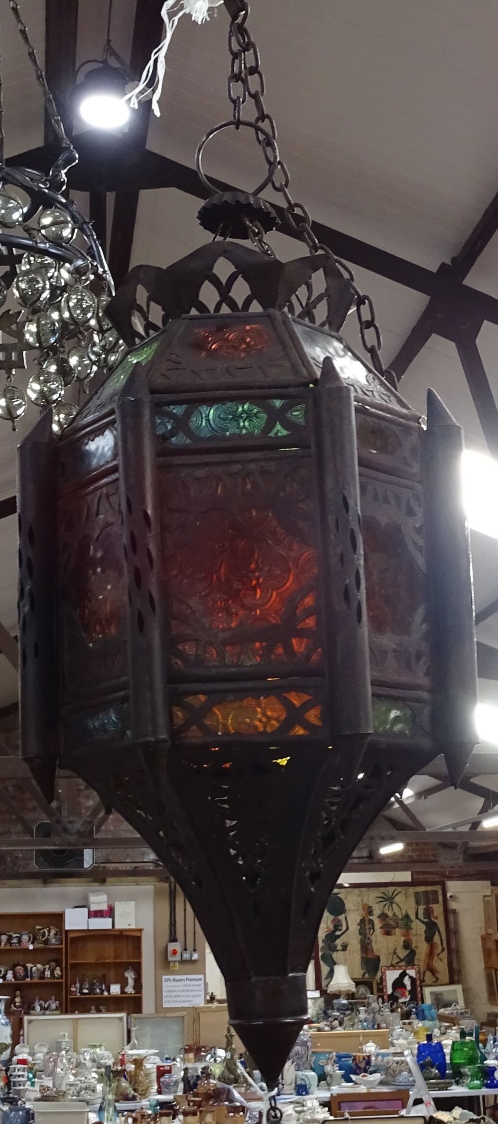 A Moroccan style metal lantern with coloured glass panels, height 60cm approx