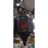 A Moroccan style metal lantern with coloured glass panels, height 60cm approx