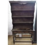 An Antique oak dresser of narrow size, with open plate rack, with single drawer under, on turned