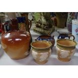 A Doulton Lambeth Highland Whiskey flagon, 17cm, a pair of Doulton pots, a jug, and sugar bowl