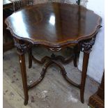 A late Victorian mahogany and satinwood-banded centre table of shaped form, with carved and
