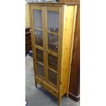 A modern polished pine display cabinet, with 2 glazed doors, W82cm, H180cm