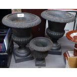 A pair of cast-iron garden urns, 27cm, and a similar small urn