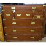 A hardwood Campaign style chest, with 8 short and long fitted drawers, brass banding, and recessed