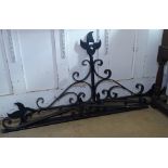 A wrought-iron scrolled pediment, and 2 others