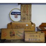 A collection of Vintage wine crates, lids, and a Player's tray