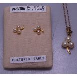 A 9ct gold and cultured pearl pendant on a 9ct gold chain, and a pair of matching earrings