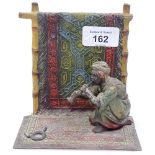 A painted spelter figure of an Arab snake charmer, height 13cm