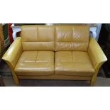 An Ekornes Stressless 2-seater settee, with tan leather upholstery, in polished beech frame