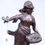 A patinated bronze figure, a girl with a bird, 47cm
