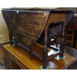 An 18th century oak gateleg table on turned baluster legs, W120cm