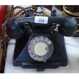 A black Bakelite dial telephone