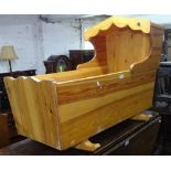 A polished pine cradle, L100cm