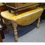 A large pine drop leaf kitchen table, on baluster legs, W132cm