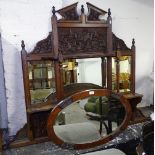 An Edwardian carved oak over-mantel mirror, and an oak-framed oval wall mirror