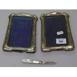 A pair of silver-fronted photo frames, and a silver and mother-of-pearl fruit knife