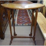 An Arts and Crafts oak bow-front side table