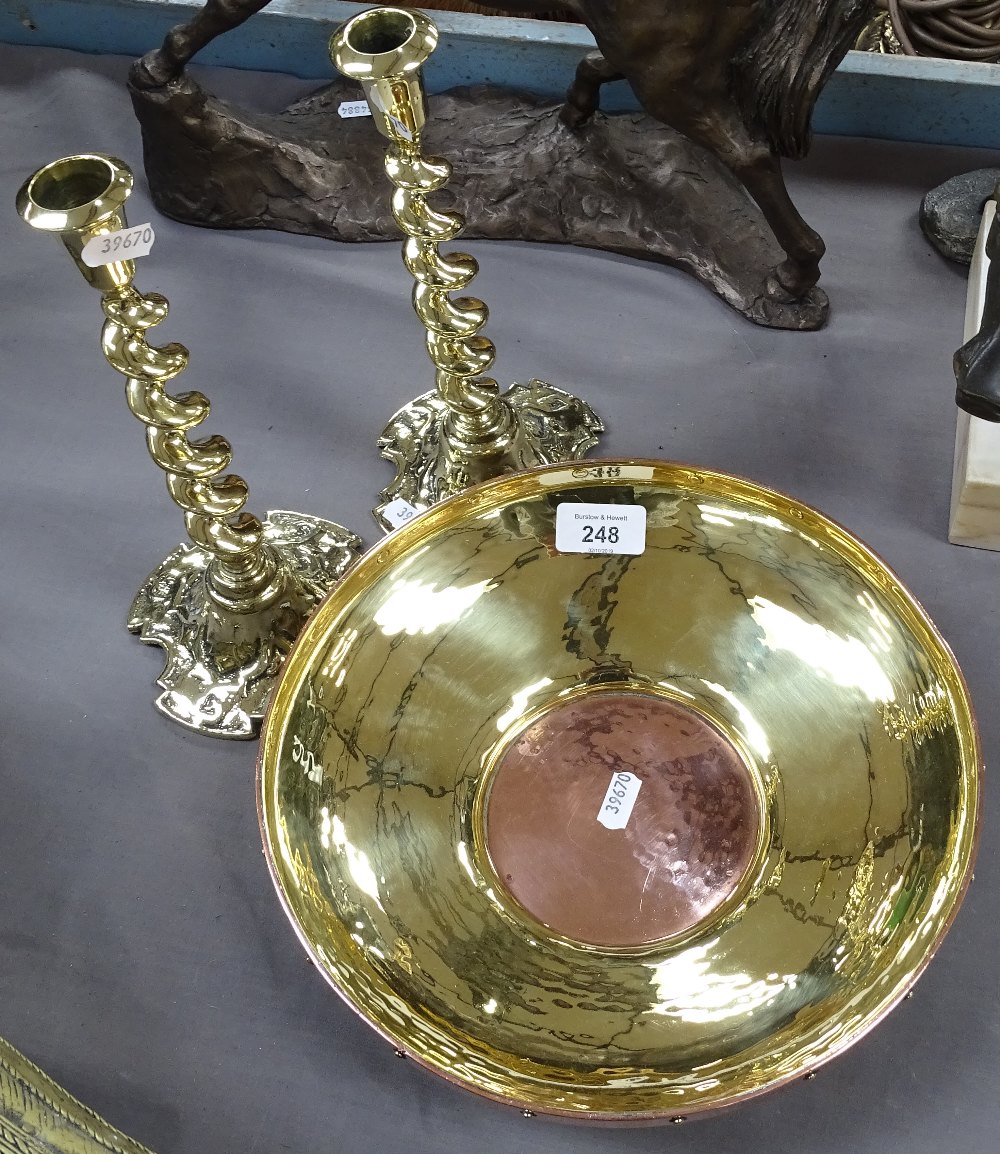 A copper and brass dish, and a pair of barley twist brass candlesticks, 25cm