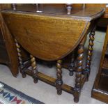 An oak oval gateleg table, with barley twist legs, W75cm