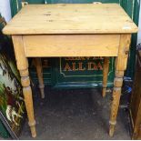 A small polished pine kitchen table on turned legs, W62cm, H74cm