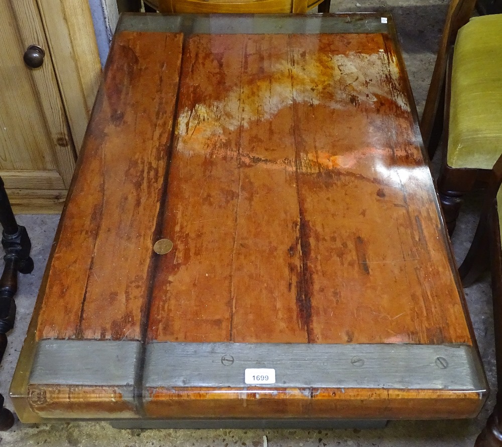 A 1960s coffee table with ship's timbers and coin embedded in perspex resin, on a steel base, W93cm