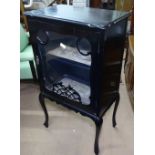 An Edwardian ebonised music cabinet, with glazed door on cabriole legs, W56cm